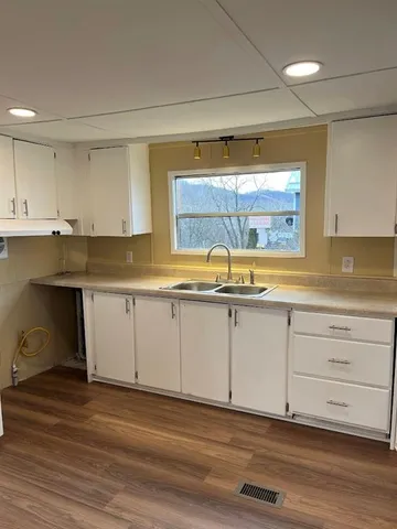 a kitchen with a refrigerator and a stove