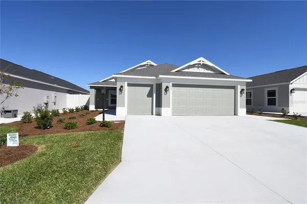 a front view of a house with a garden and yard