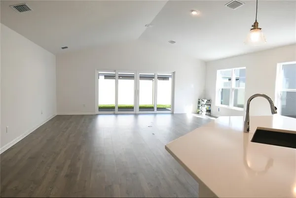 a view of a kitchen with a sink and a large window