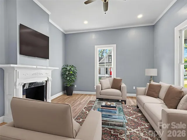 a living room with furniture fireplace and flat screen tv