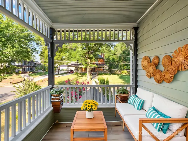 a balcony with furniture and a potted plant