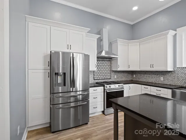 a kitchen with granite countertop stainless steel appliances and wooden cabinets