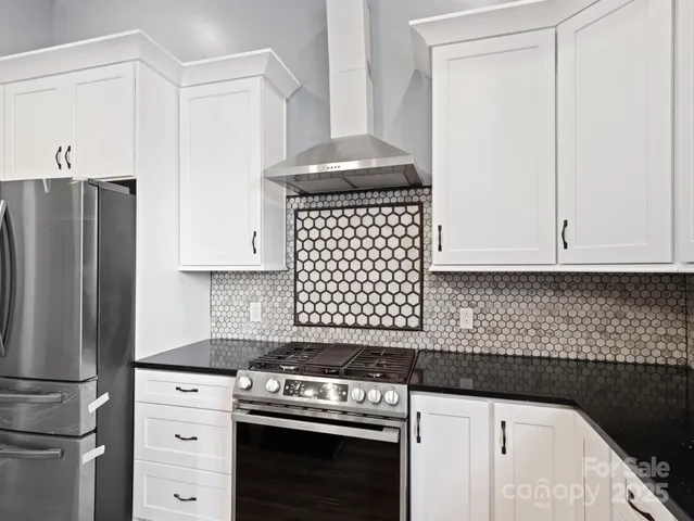 a kitchen with a stove and a refrigerator