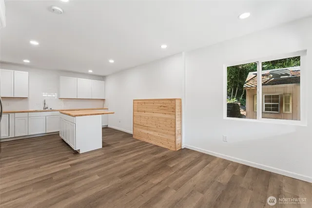 a kitchen with a refrigerator and a stove top oven