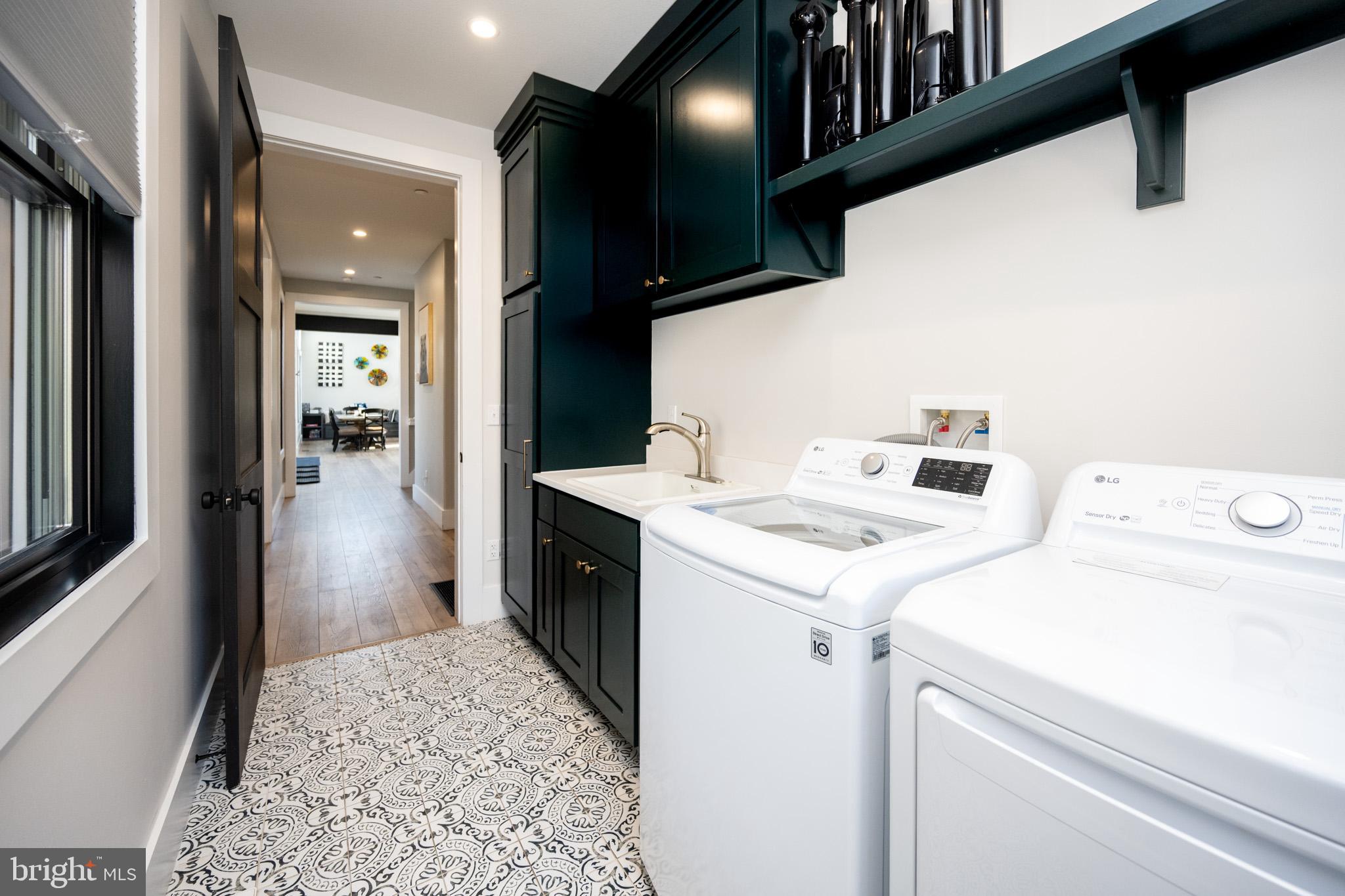 415 Mountaintop Road McHenry, MD 21541 - Photo 15 of 134 a view of washer and dryer with kitchen in the background