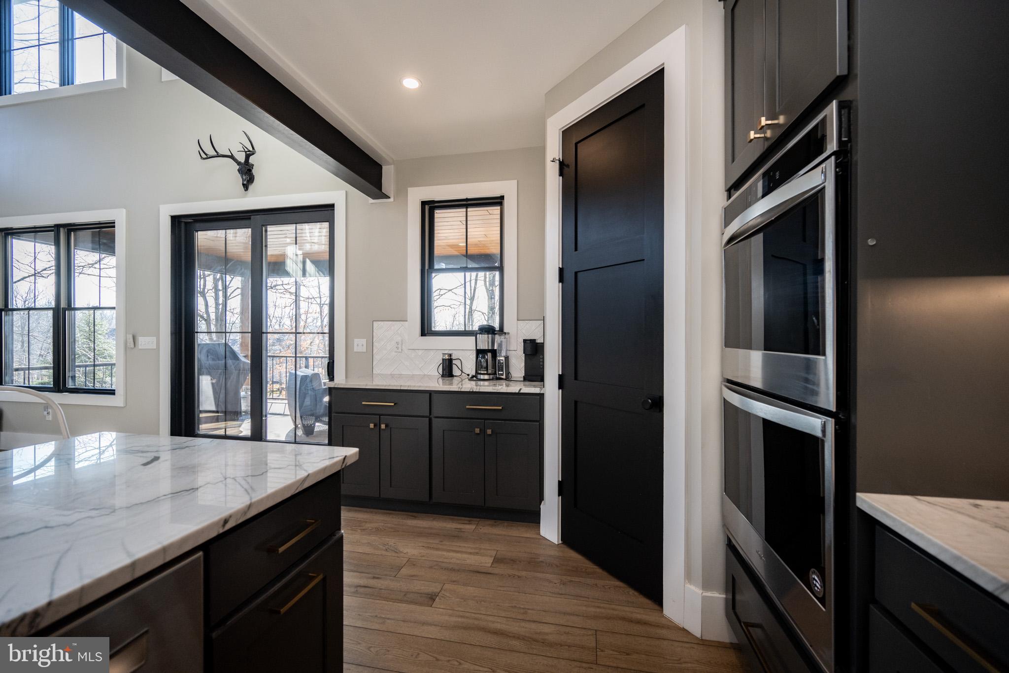 415 Mountaintop Road McHenry, MD 21541 - Photo 32 of 134 a kitchen with stainless steel appliances granite countertop a refrigerator a sink dishwasher a stove and white countertops with wooden floor