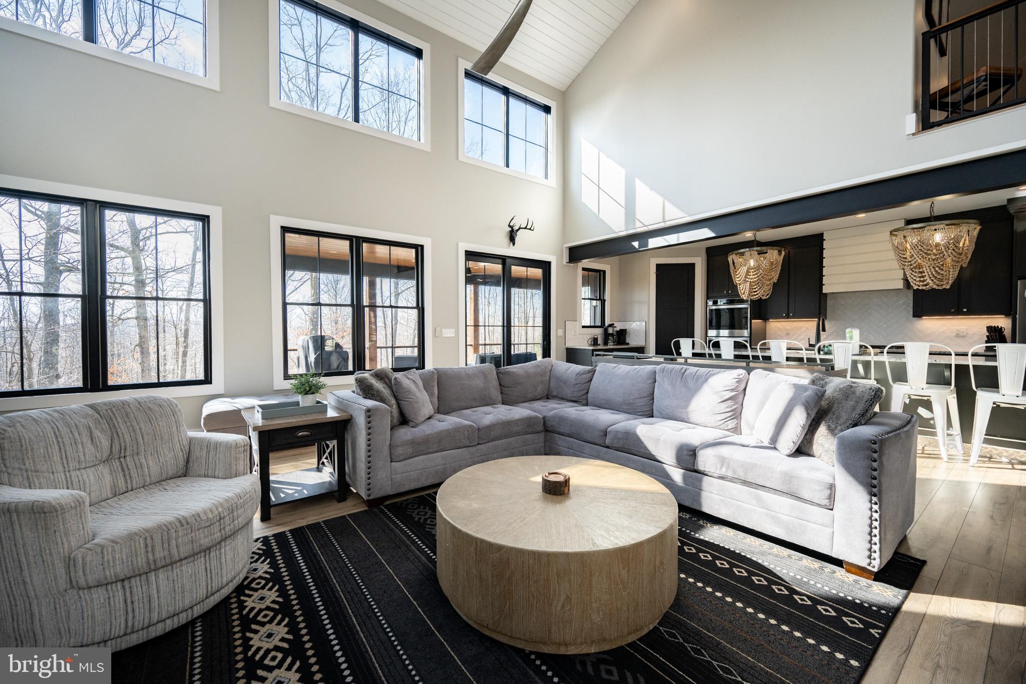 415 Mountaintop Road McHenry, MD 21541 - Photo 43 of 134 a living room with furniture a flat screen tv and kitchen view