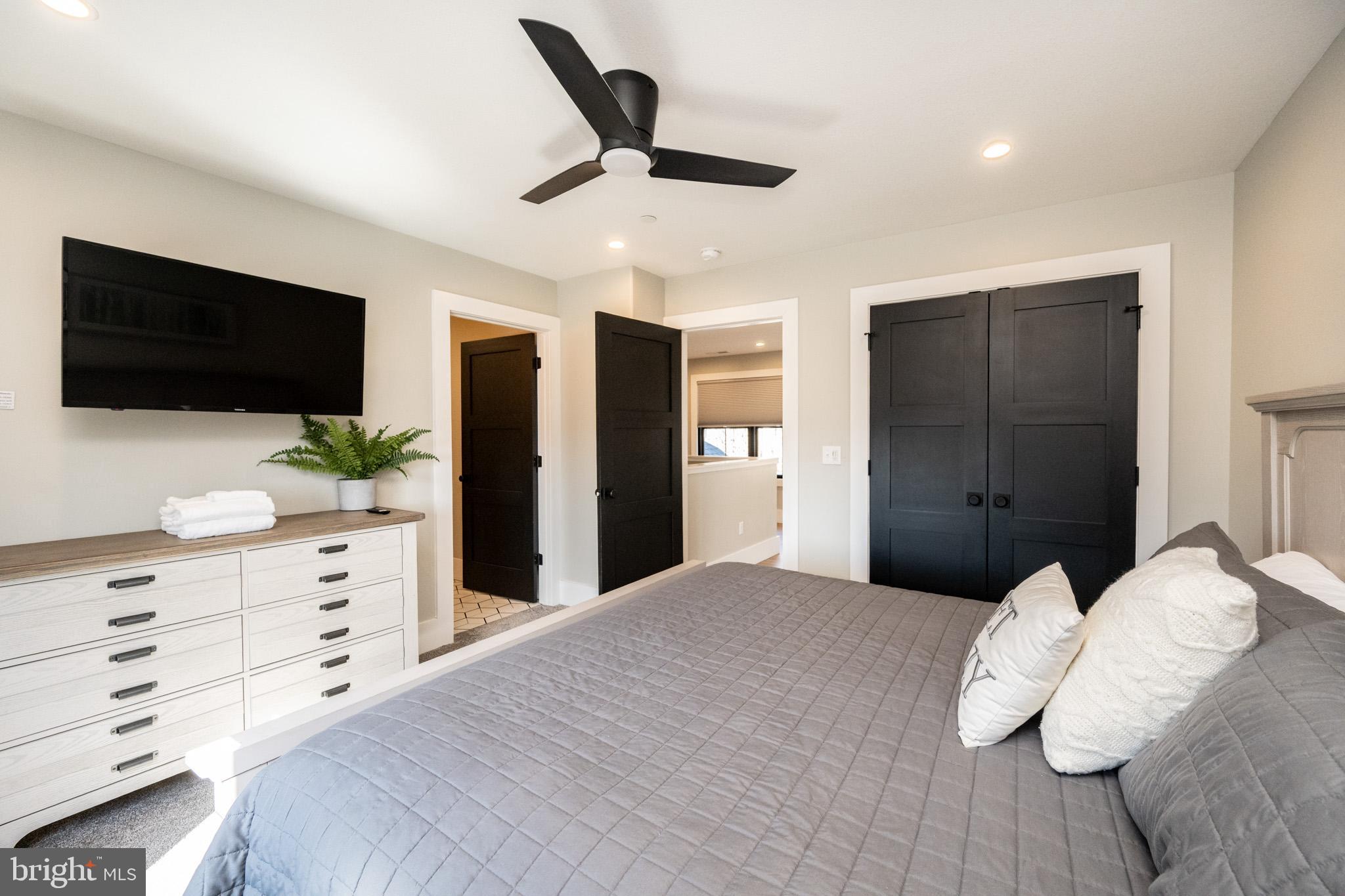 415 Mountaintop Road McHenry, MD 21541 - Photo 52 of 134 a bedroom with a large bed and a flat screen tv