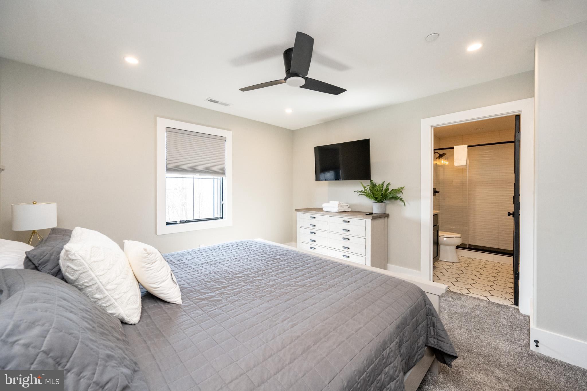 415 Mountaintop Road McHenry, MD 21541 - Photo 55 of 134 a bedroom with a bed and a flat tv screen on dresser