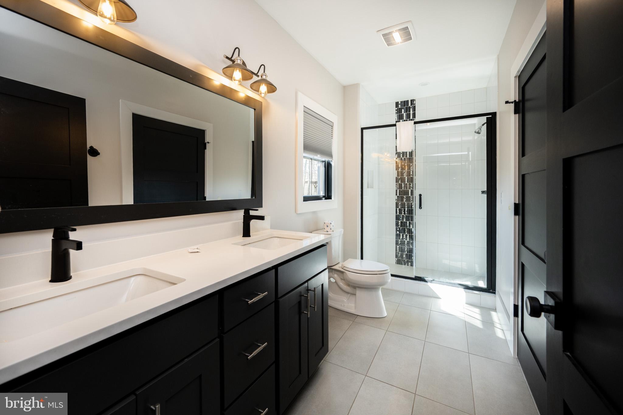 415 Mountaintop Road McHenry, MD 21541 - Photo 80 of 134 a bathroom with a double vanity sink toilet and mirror