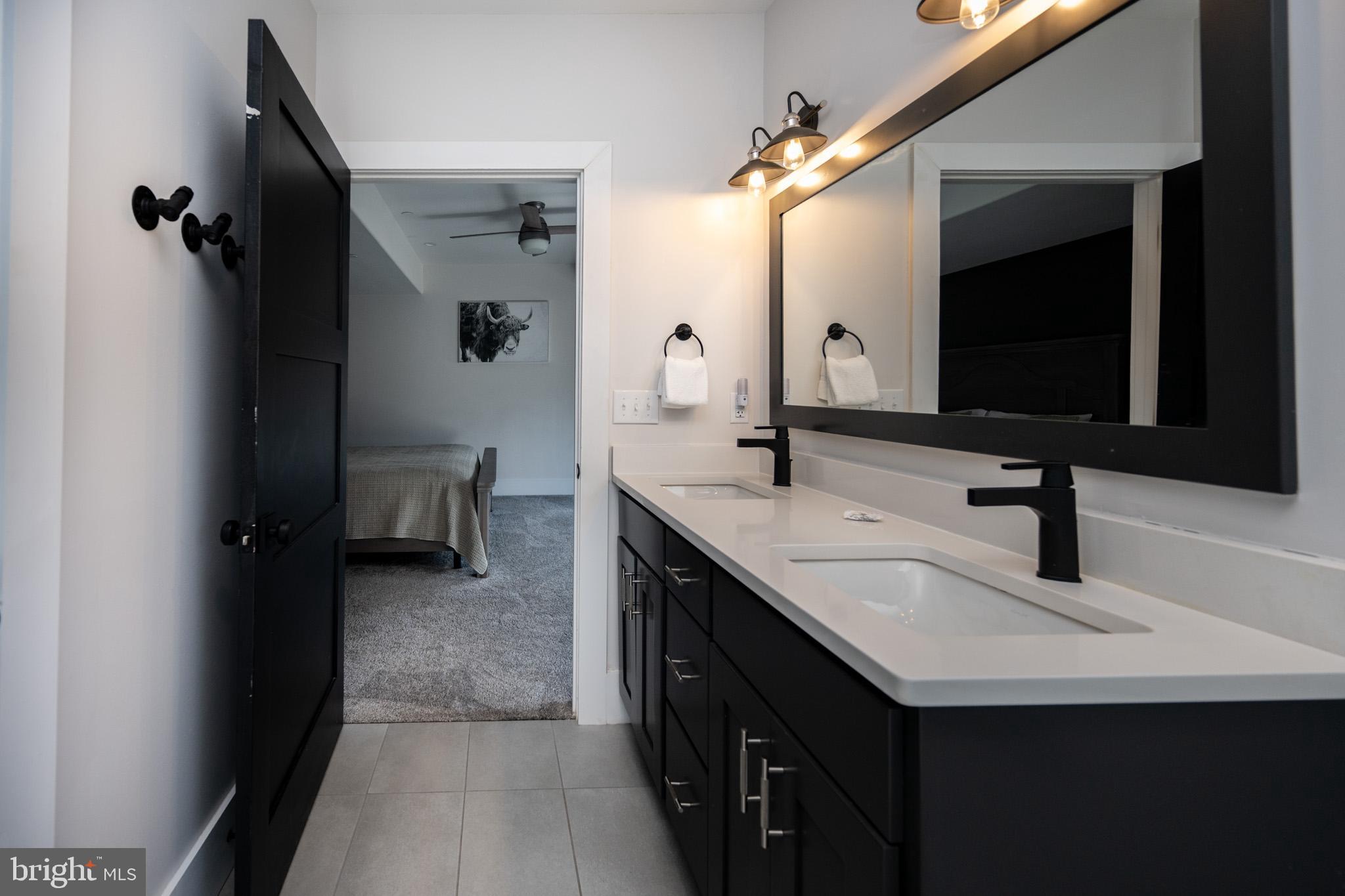 415 Mountaintop Road McHenry, MD 21541 - Photo 83 of 134 a bathroom with a double vanity sink a and a mirror