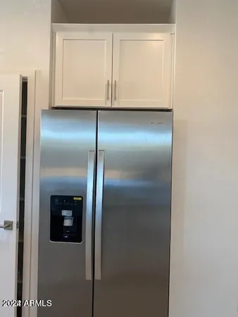 a view of a refrigerator in kitchen