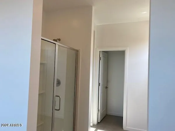 a bathroom with a glass shower door