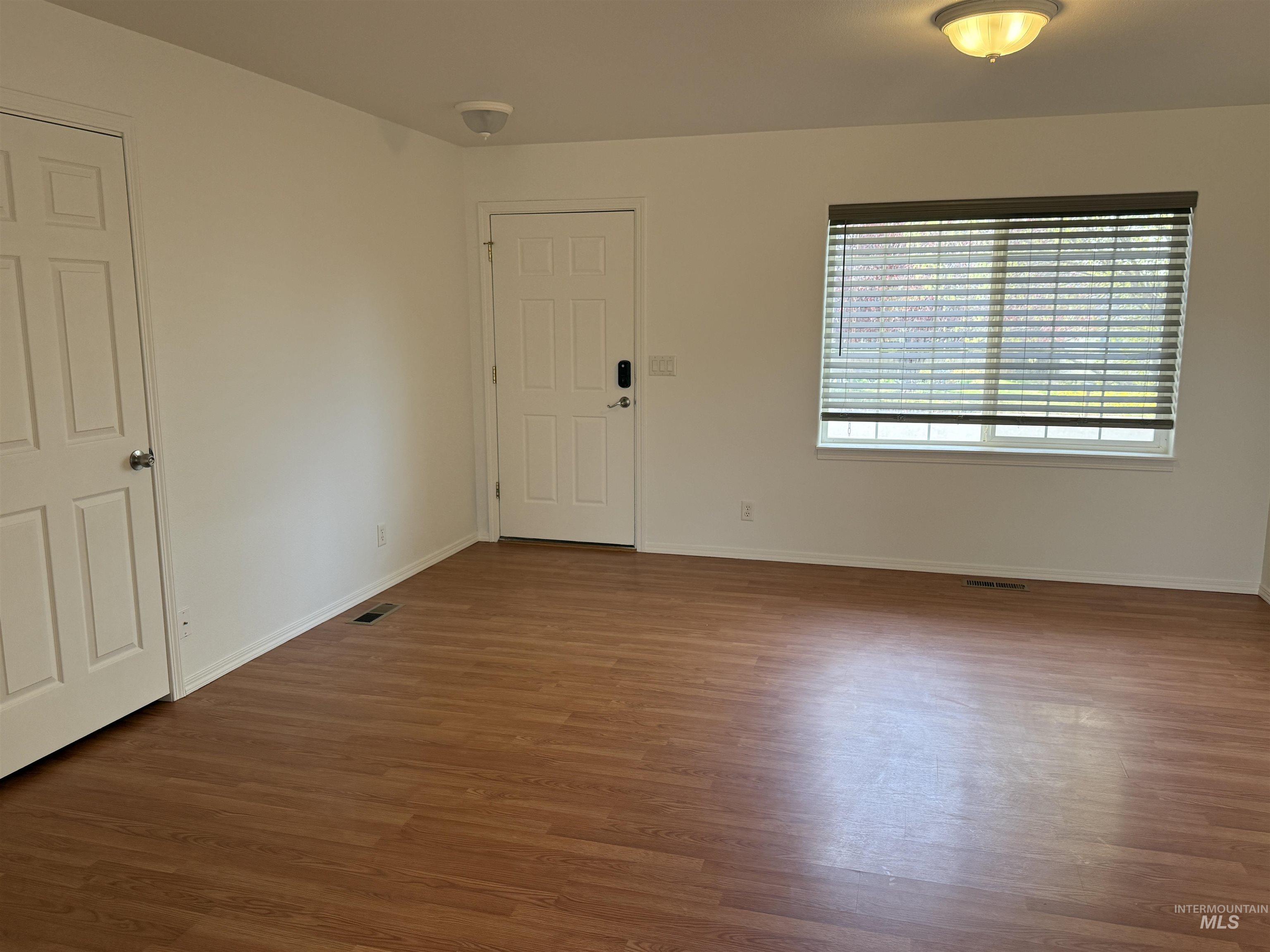 523 Morning Dove Way Marsing, ID 83639 - Photo 8 of 23 Empty room with dark wood-style flooring