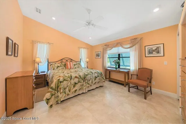 a bedroom with a balcony a bed and a walk in closet