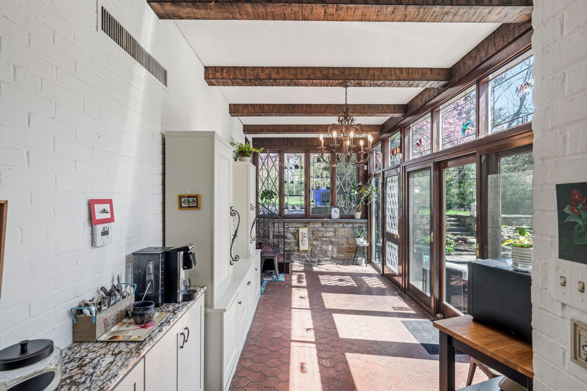 1735 Ashbourne Road Elkins Park, PA 19027 - Photo 19 of 82 a room with furniture a flat screen tv and a floor to ceiling window