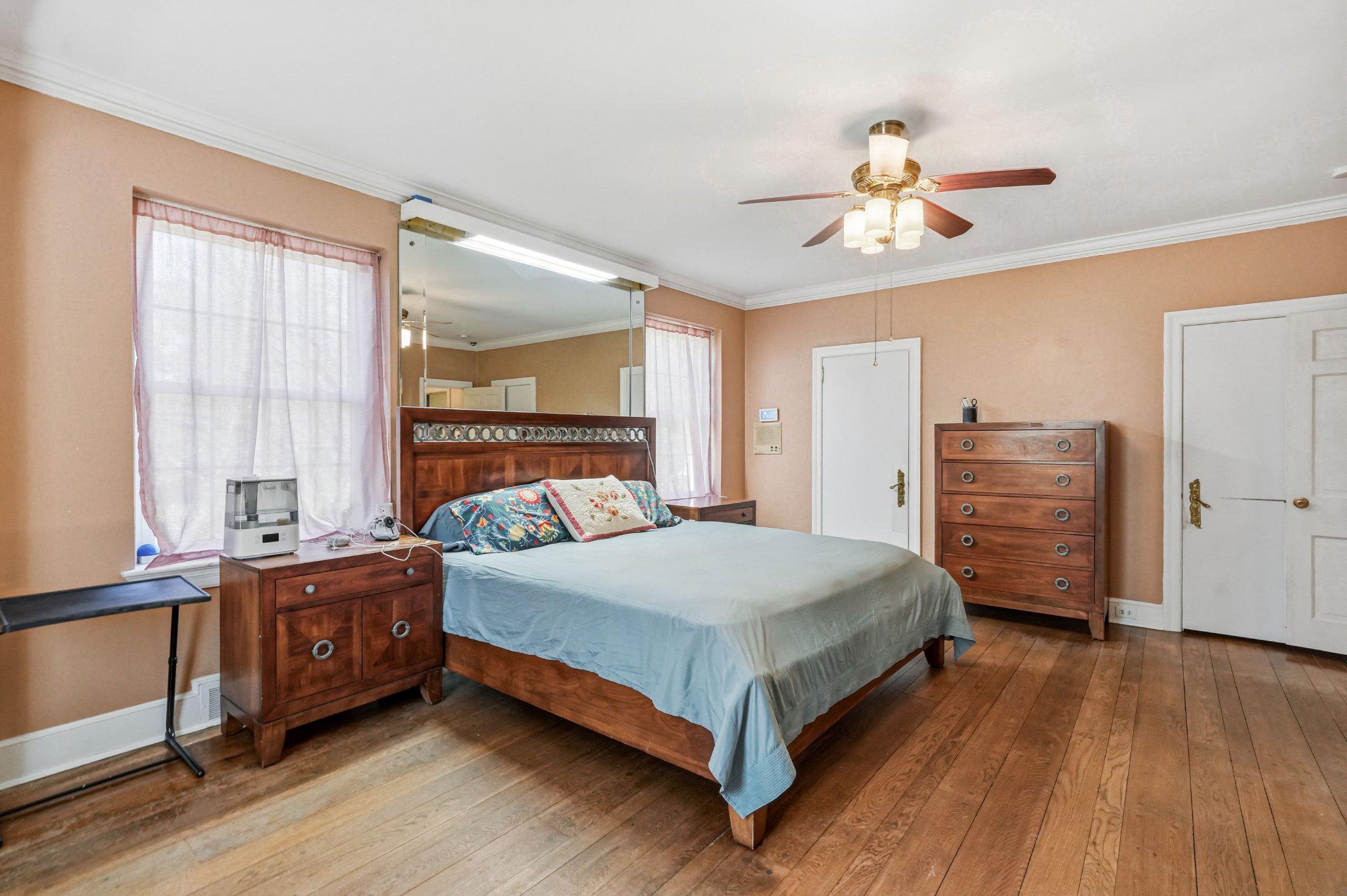 1735 Ashbourne Road Elkins Park, PA 19027 - Photo 29 of 82 a bedroom with a bed and a chandelier