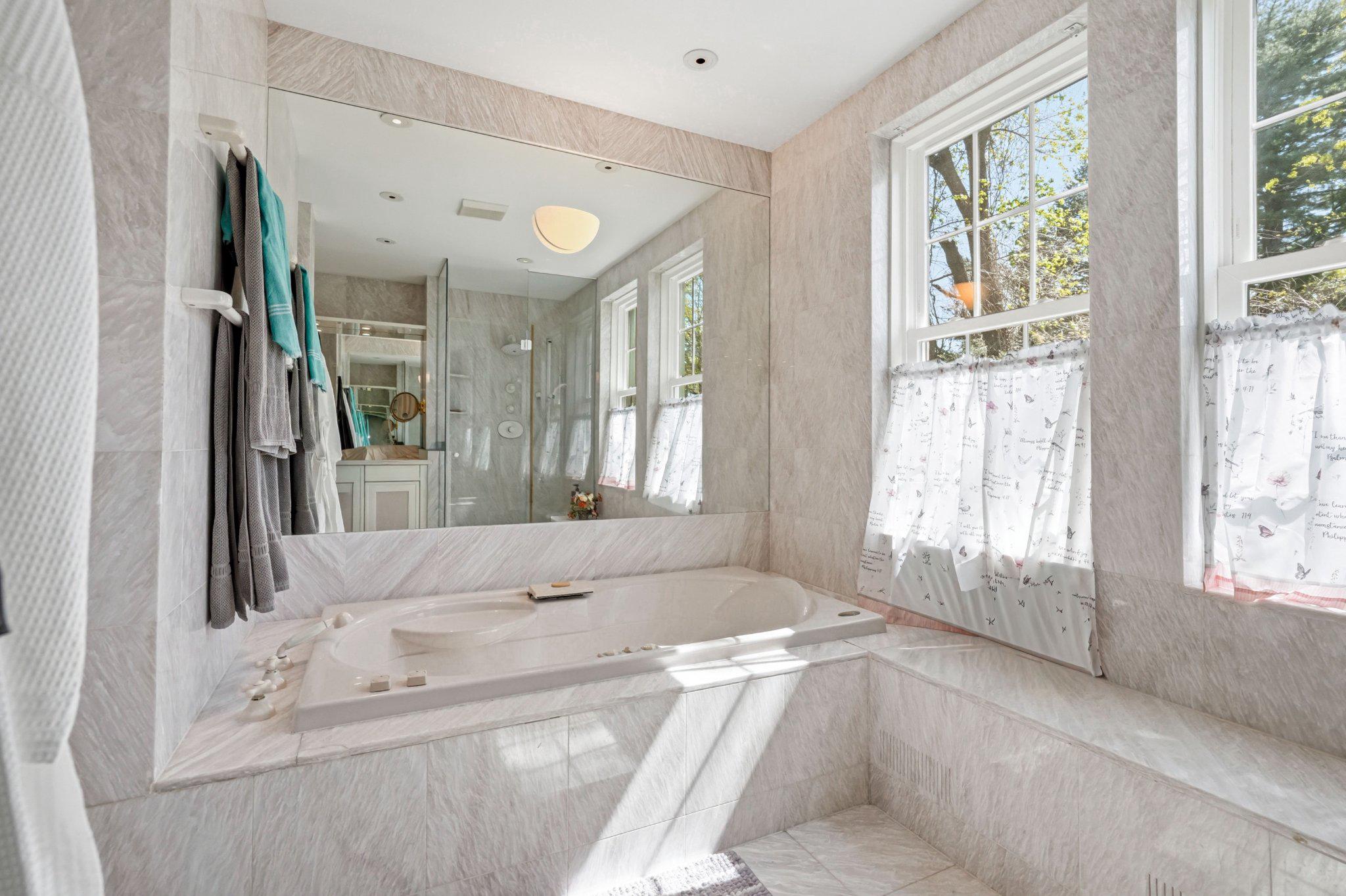 1735 Ashbourne Road Elkins Park, PA 19027 - Photo 31 of 82 a spacious bathroom with a tub sink and mirror