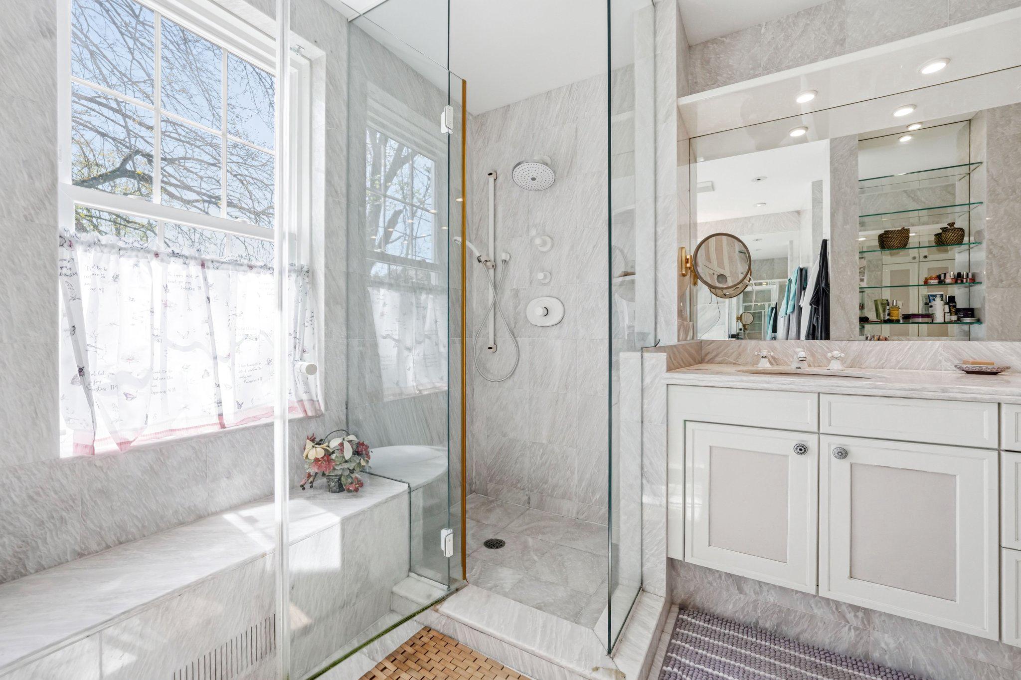 1735 Ashbourne Road Elkins Park, PA 19027 - Photo 32 of 82 a bathroom with a double vanity sink a large mirror a shower and bathtub