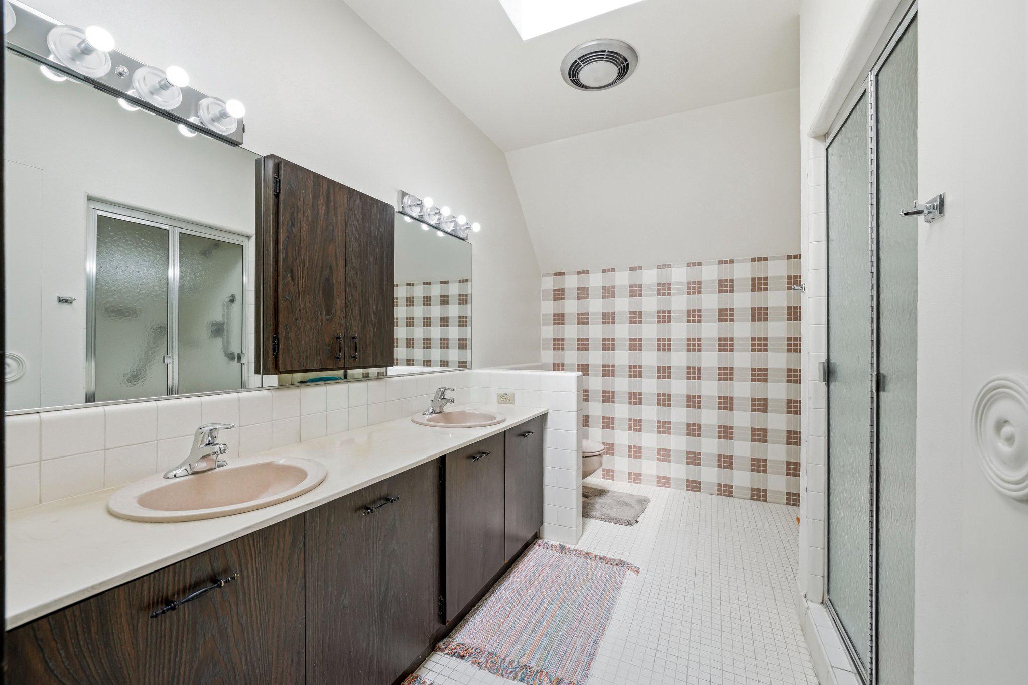 1735 Ashbourne Road Elkins Park, PA 19027 - Photo 42 of 82 a bathroom with a sink a shower a mirror and a bathtub