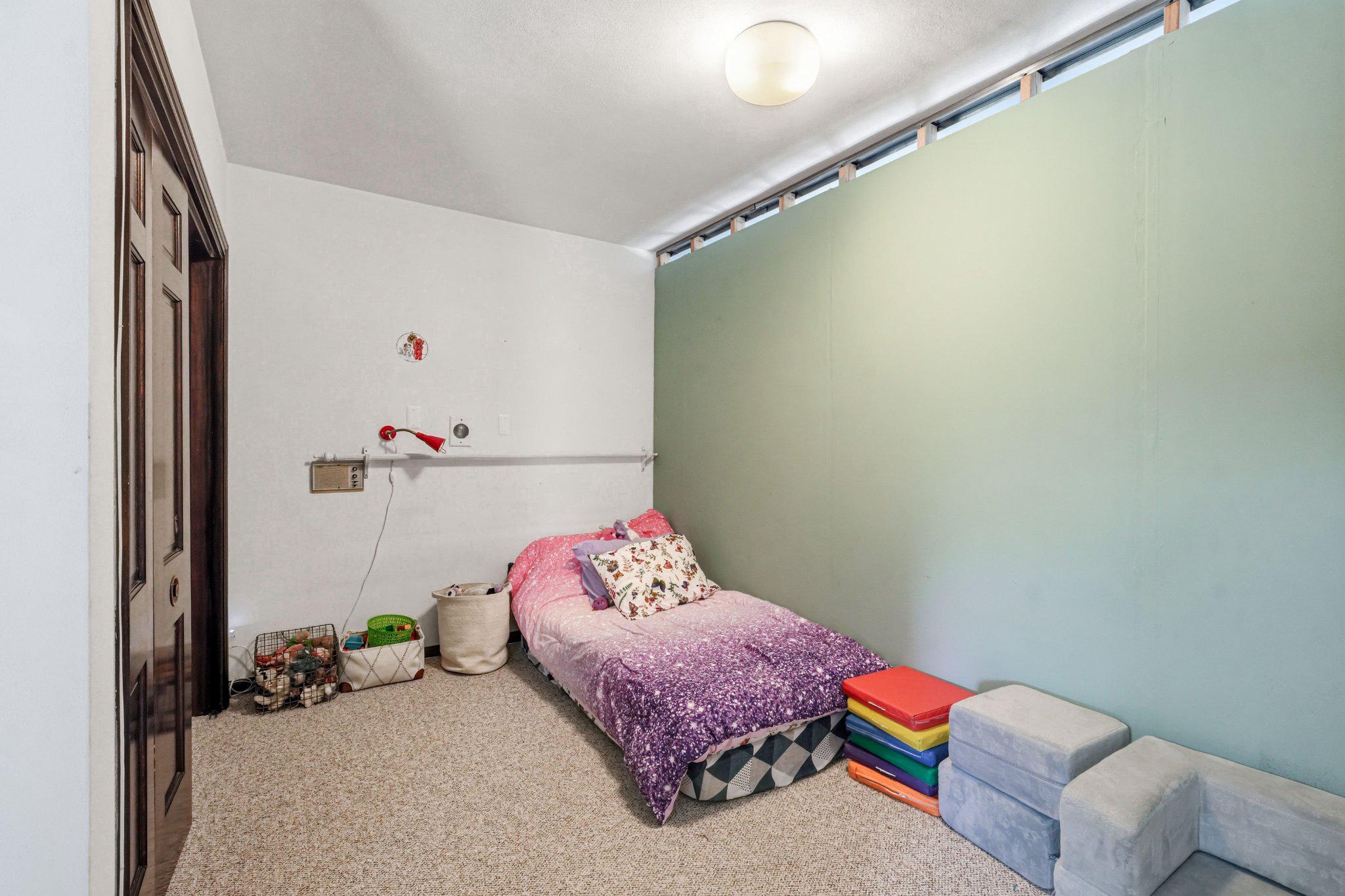 1735 Ashbourne Road Elkins Park, PA 19027 - Photo 44 of 82 a bedroom with a bed and a potted plant on dresser