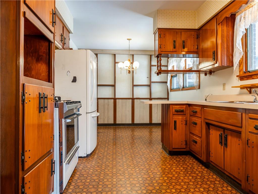 1012 Blaine Road Monaca, PA 15061 - Photo 11 of 50 a kitchen with stainless steel appliances granite countertop a refrigerator a stove and a sink with wooden floor