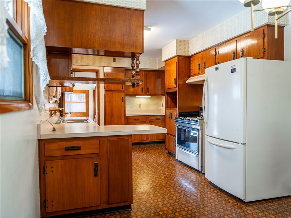 1012 Blaine Road Monaca, PA 15061 - Photo 13 of 50 a kitchen with stainless steel appliances a refrigerator and a stove