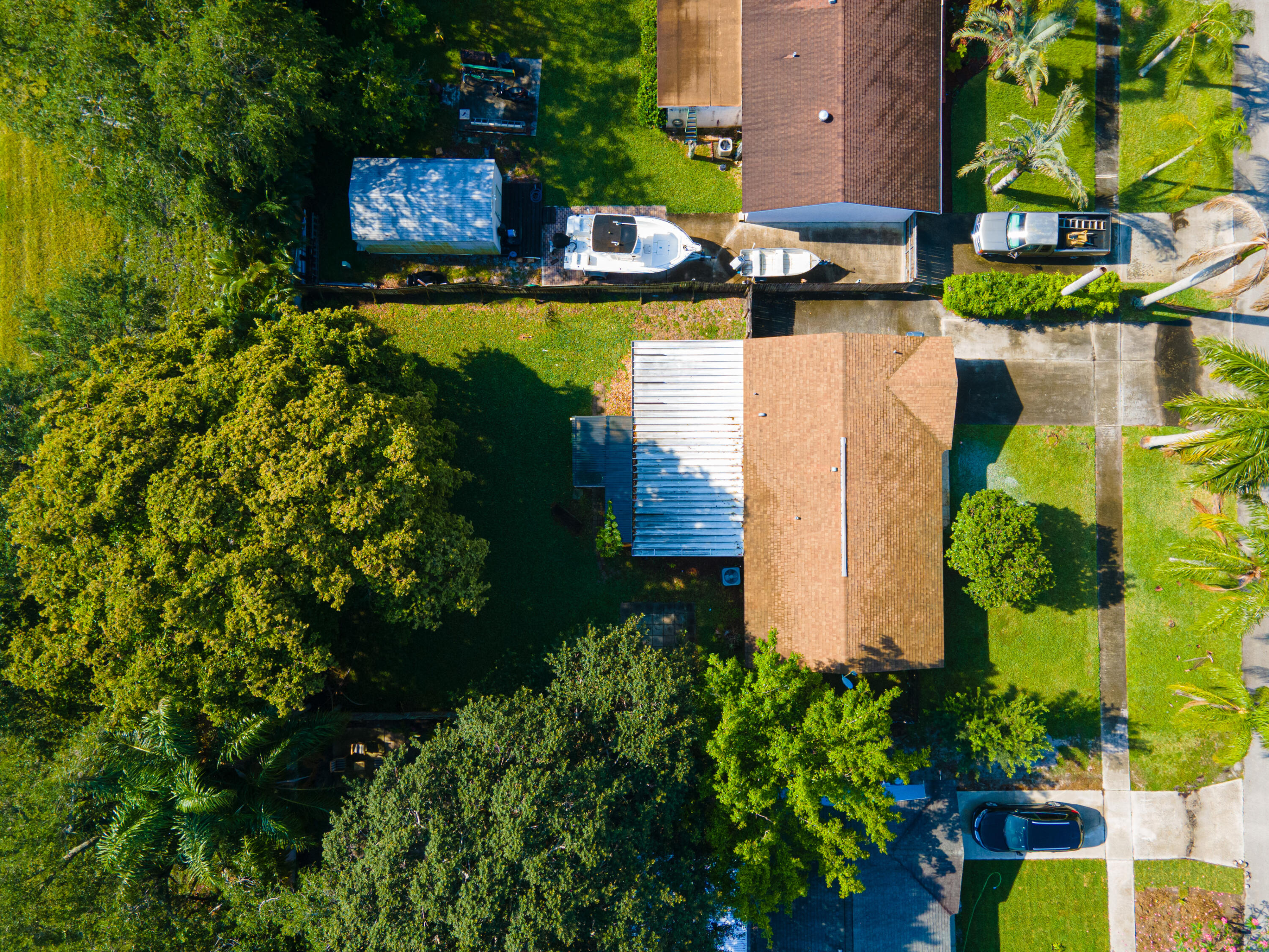 4661 Poseidon Place Lake Worth, FL 33463 - Photo 1 of 36 an aerial view of a house with a garden and lake view