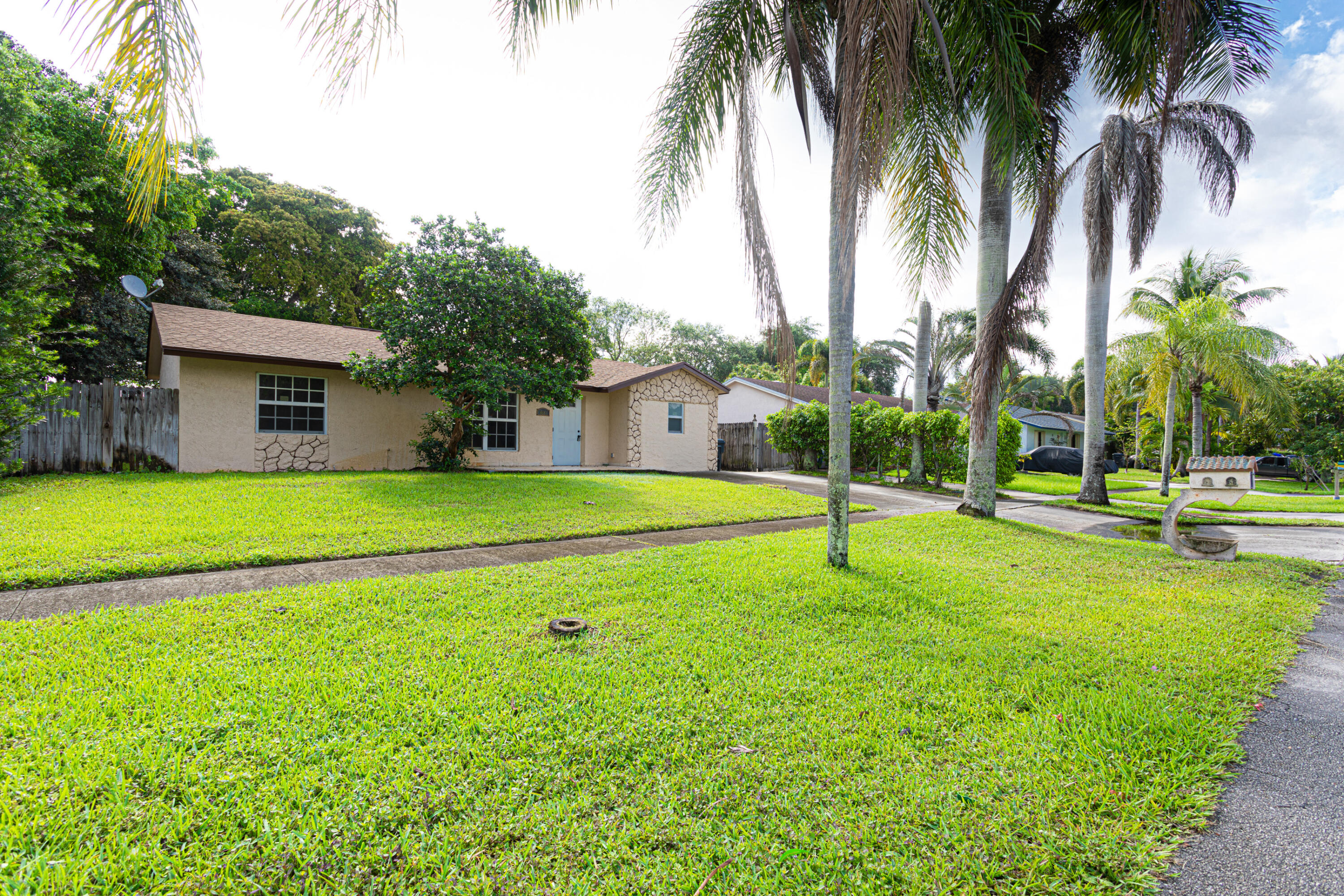4661 Poseidon Place Lake Worth, FL 33463 - Photo 11 of 36 a house with palm tree in front of it