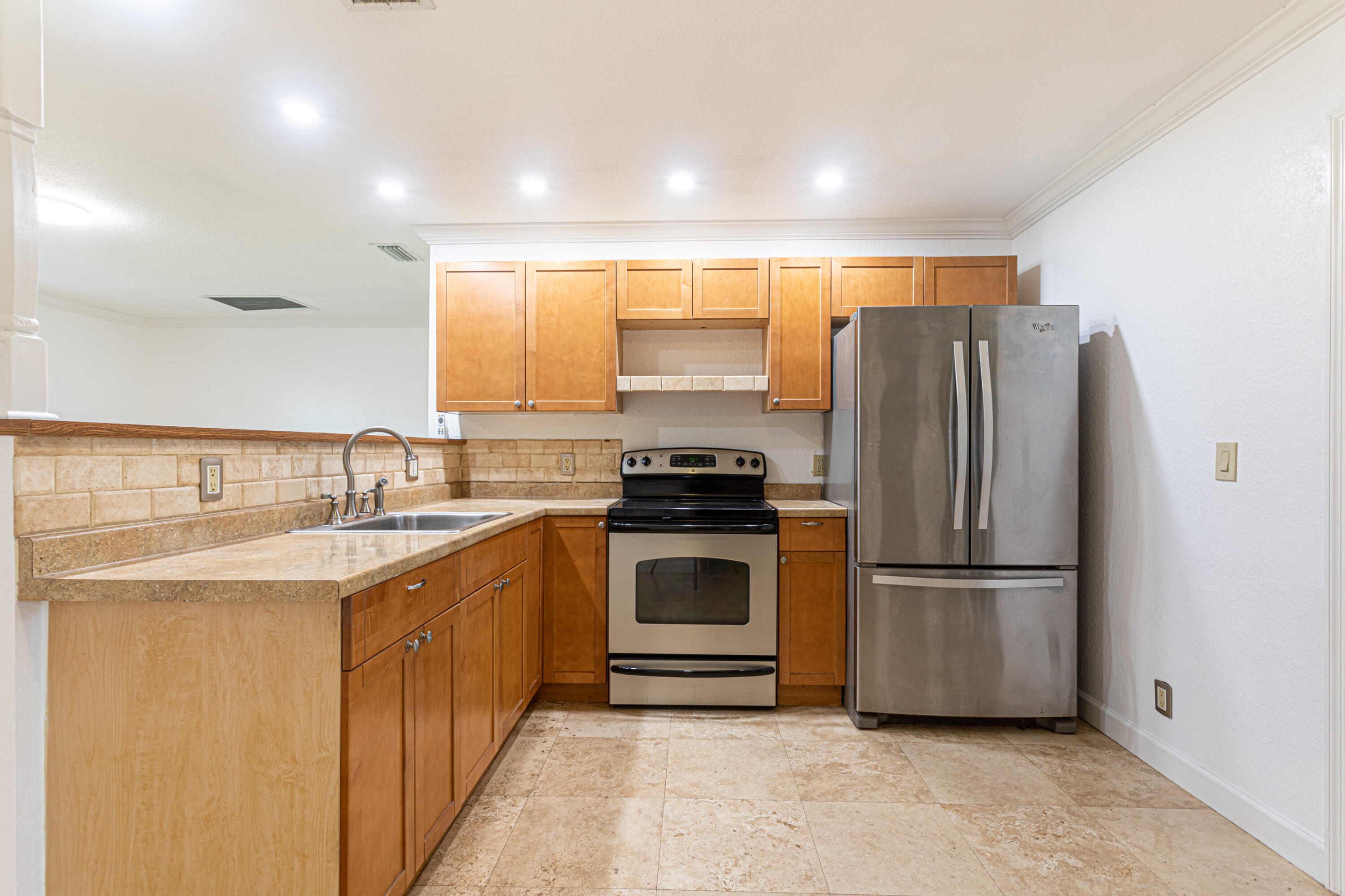 4661 Poseidon Place Lake Worth, FL 33463 - Photo 31 of 36 a kitchen with a refrigerator and a sink