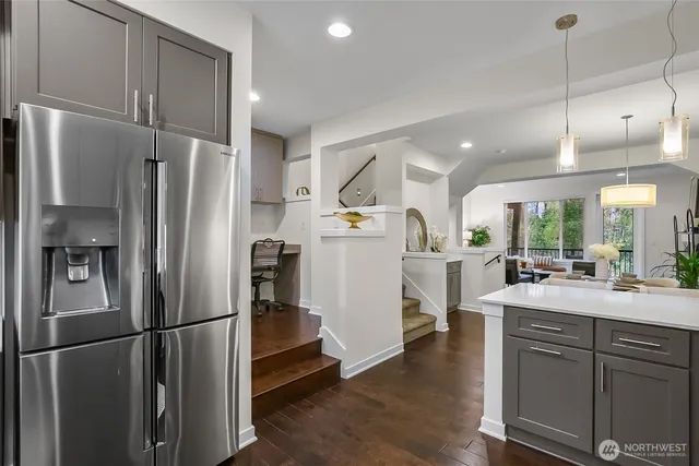 a kitchen with refrigerator a sink and white cabinets