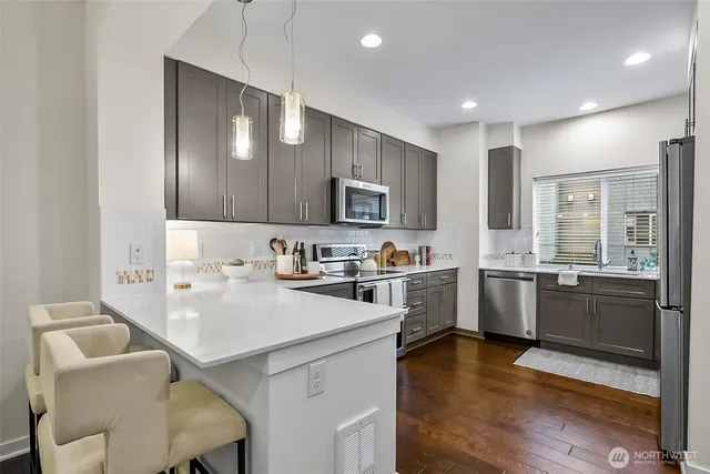 a kitchen with a sink cabinets and wooden floor