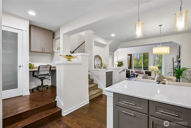 a kitchen with sink a counter and chairs