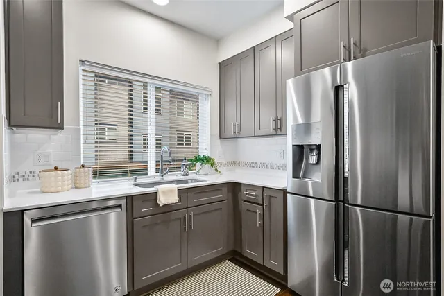 a kitchen with stainless steel appliances a sink stove and refrigerator