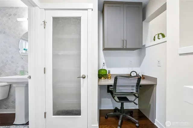 a bathroom with a sink mirror and toilet