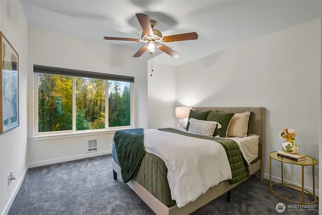 a spacious bedroom with a large bed and a chandelier