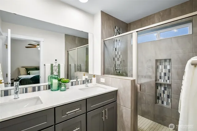 a bathroom with a sink double vanity and a shower