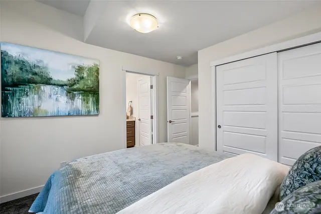 a bedroom with a bed and a lamp