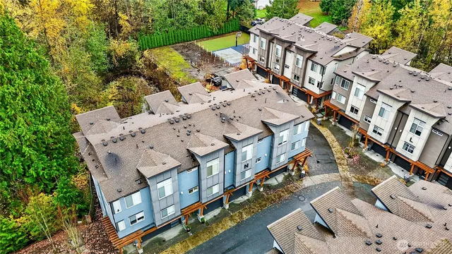 a front view of a house with a yard and fountain in middle