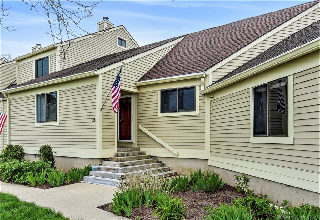 152 Sandy Point Road, Unit 152 Old Saybrook, CT 06475 - Photo 1 of 1 a view of a house with a small yard and a large window