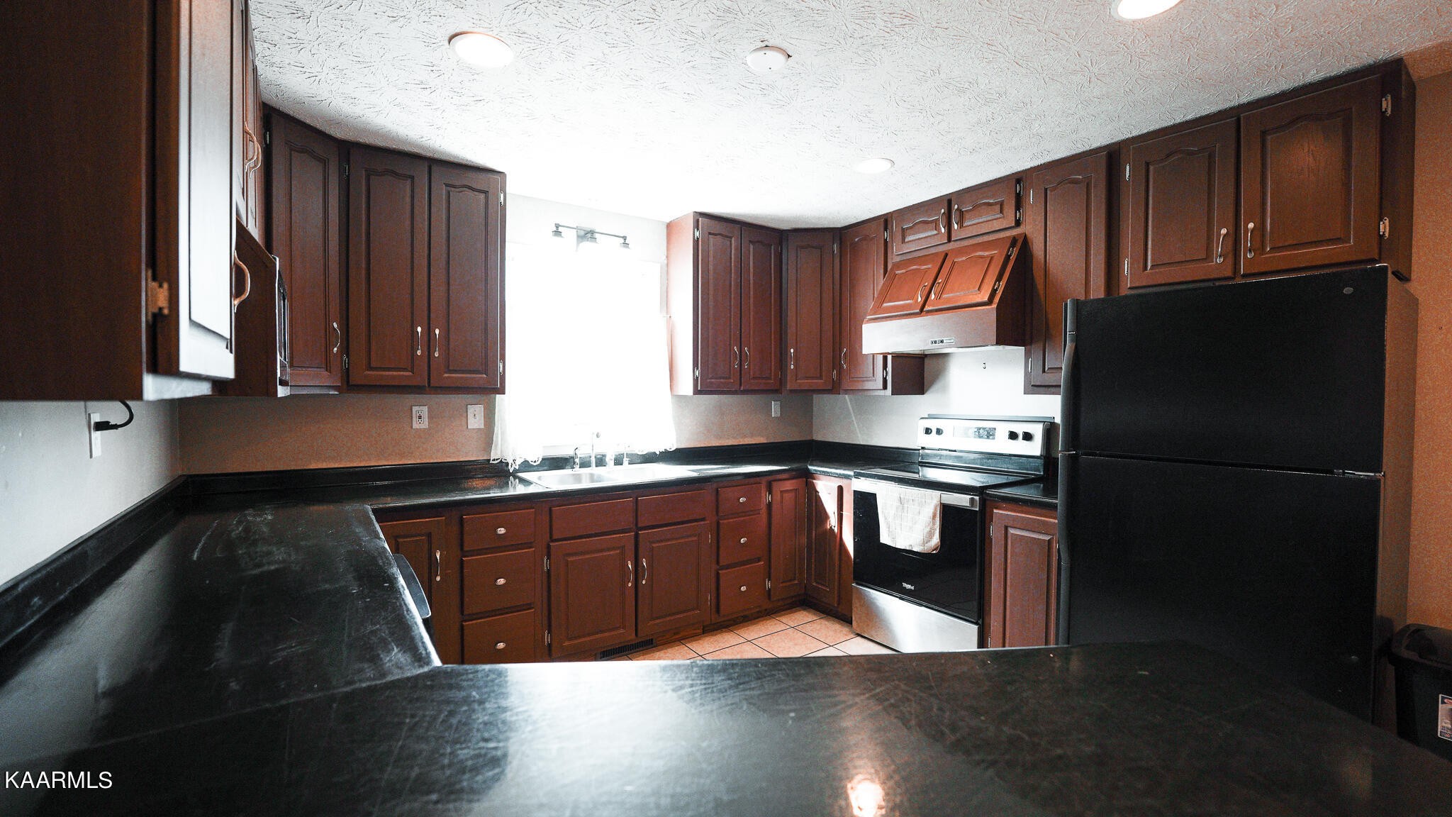 1440 Sulphur Springs Road Clinton, TN 37716 - Photo 13 of 24 a kitchen with stainless steel appliances granite countertop a stove a refrigerator and a sink with wooden cabinets