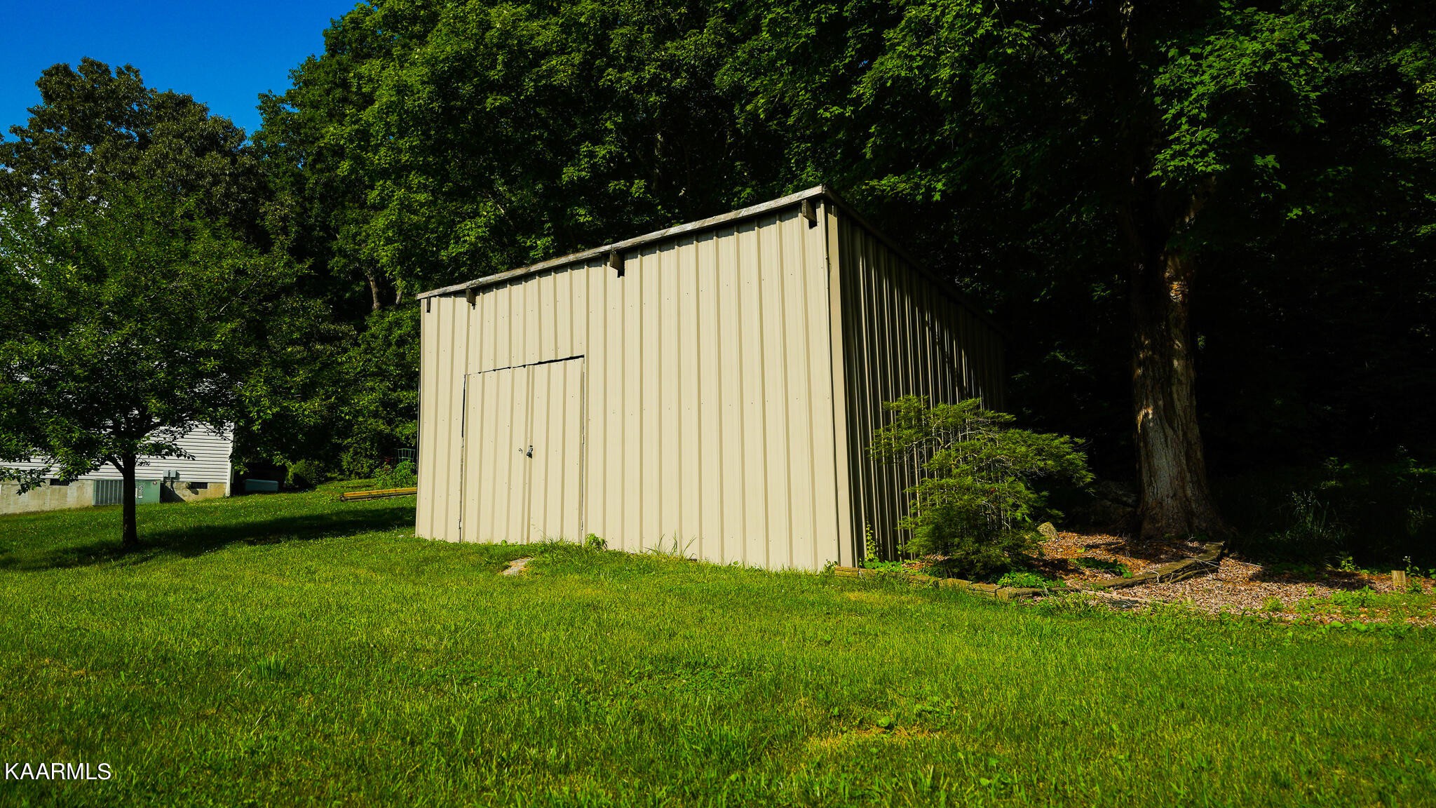 1440 Sulphur Springs Road Clinton, TN 37716 - Photo 5 of 24 a view of backyard with garden and trees