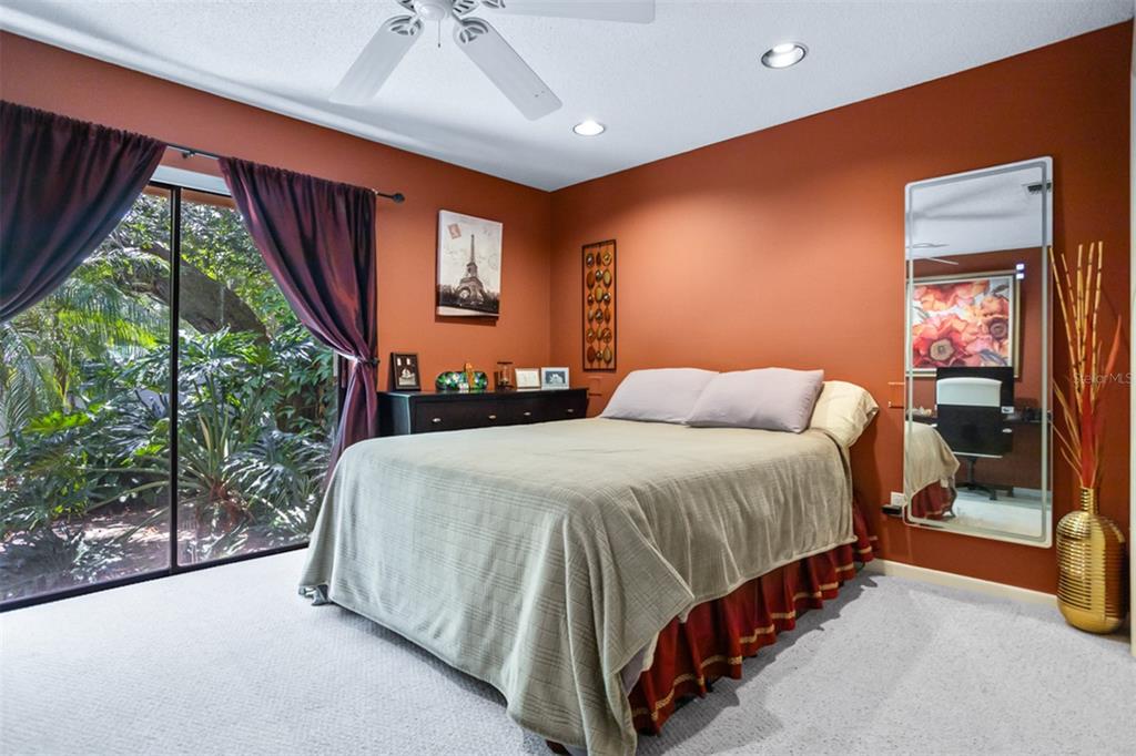 11407 Orilla Del Rio Place Temple Terrace, FL 33617 - Photo 17 of 39 a bedroom with a bed lamp and window