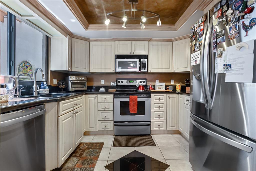11407 Orilla Del Rio Place Temple Terrace, FL 33617 - Photo 3 of 39 a kitchen with stainless steel appliances a refrigerator sink and microwave