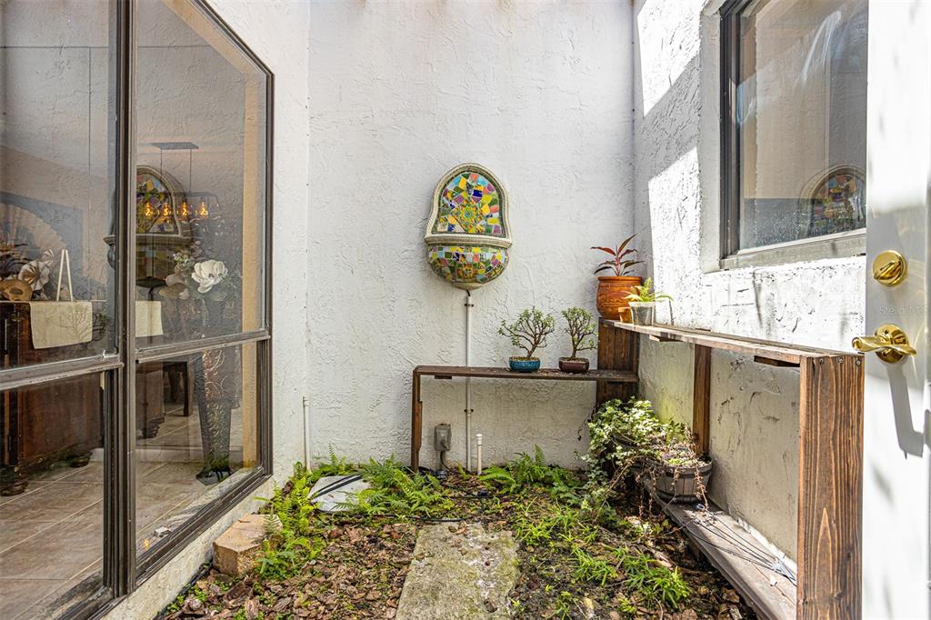 11407 Orilla Del Rio Place Temple Terrace, FL 33617 - Photo 5 of 39 a vase of flowers sitting next to a window