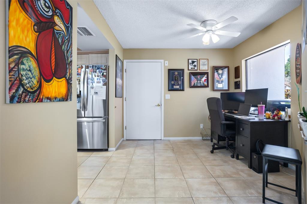 11407 Orilla Del Rio Place Temple Terrace, FL 33617 - Photo 6 of 39 a view of a workspace with furniture and a window