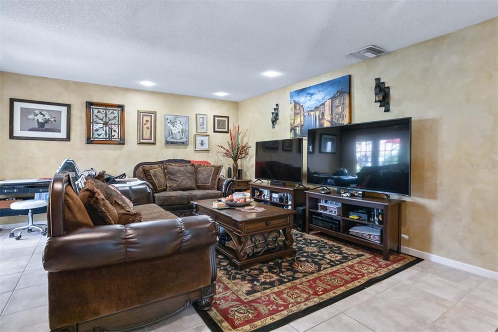 11407 Orilla Del Rio Place Temple Terrace, FL 33617 - Photo 9 of 39 a living room with furniture and a flat screen tv