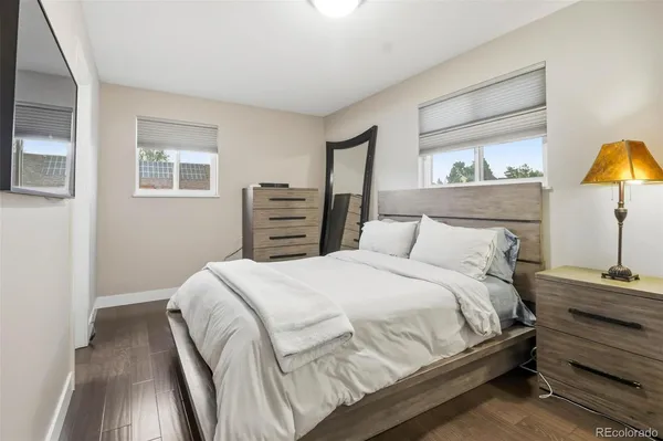 a bedroom with a bed and a night stand