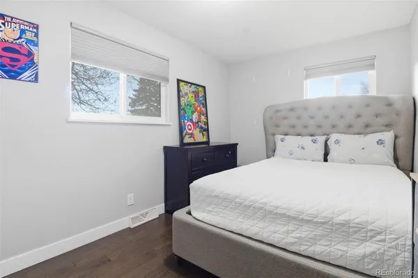 a bedroom with a bed and a painting on the wall