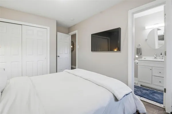 a bedroom with a bed and a mirror